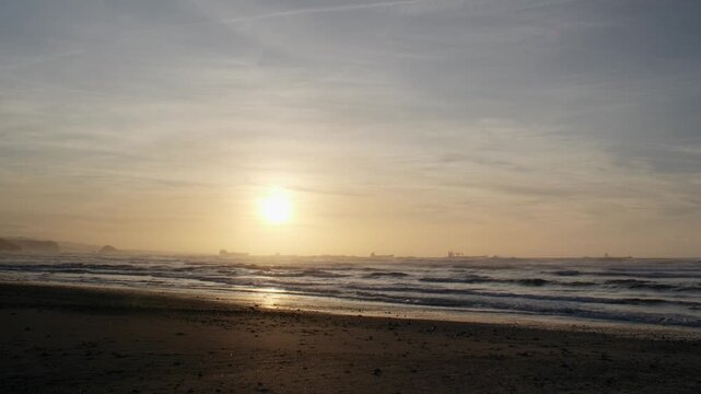 Golden Sunset Over the Sea with Cargo Ships on the Horizon