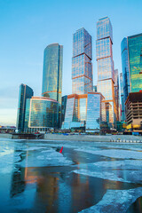 Naklejka premium High-rise buildings of the Moscow City business center on the banks of the Moskva River at dawn.