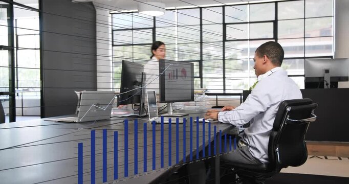 Diverse coworkers discussing data at meeting table, Asian woman in white blouse pointing at monitor