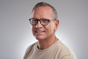 Fototapeta premium Portrait, man and optometry with glasses in studio for eye care, vision and improve eyesight. Mockup space, mature person and eyewear for wellness, lens prescription and frame on white background