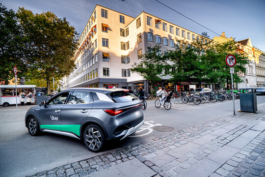 New electric Uber taxi in Copenhagen, daily life on streets Danish city.