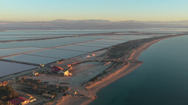 Aerial view of salinas de santa pola salt flats and mediterranean sea in spain