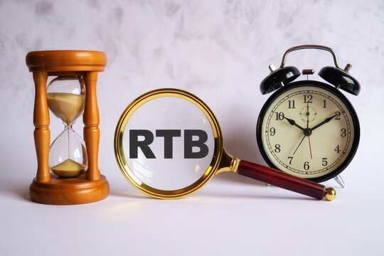 Real-time bidding concept with hourglass and alarm clock isolated on white background