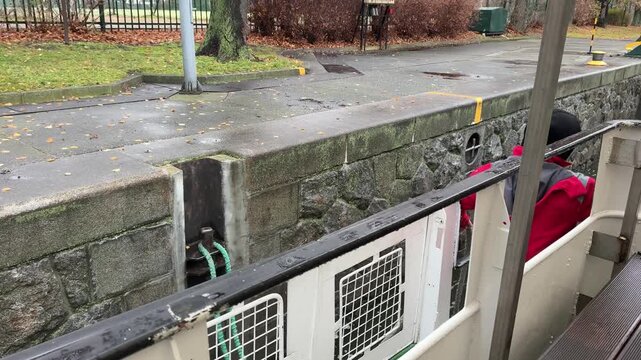 Prague Vltava river red jacket person docking boat pier city river Europe sightseeing urban scene