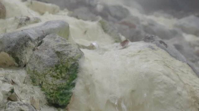 Close up view of the hot stream and sulfur sediments on the volcano of Mendeleev on Kunashir island. Russia