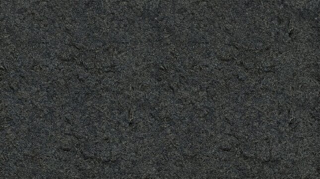 High resolution image of a dark grey rock texture with detailed grains