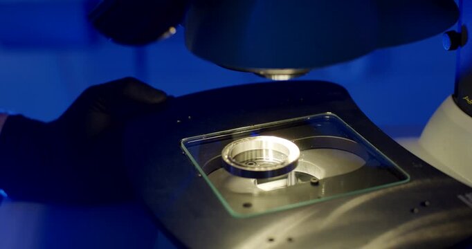 Metal ring component placed on a microscope stage for inspection in a laboratory setting