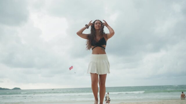 Brave woman advances. Fearless lady moves toward shore. Selfassured woman confidently approaches welcoming coast. Woman full of courage strides purposefully and boldly into embracing shoreline
