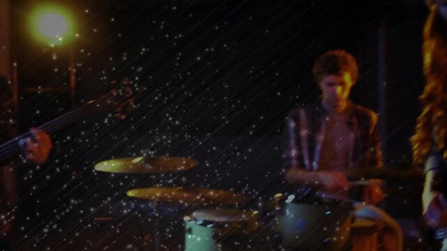 Camera opening drum closeups, drummer striking, band joining, singer moving to mic, playing song