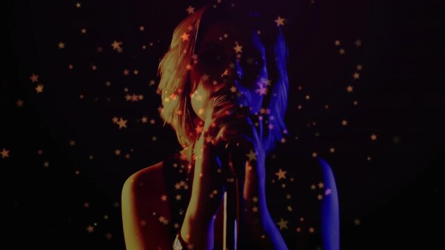Camera pulling back and star projection revealing singer holding mic, leaning, delivering vocals