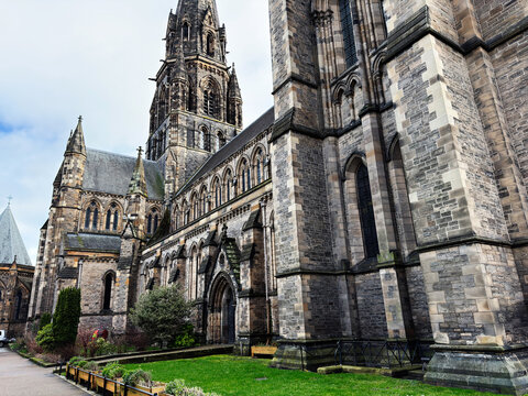 Historic gothic St Mary's Episcopal Cathedral exterior in Edinburgh, Scotland, UK with stone architecture, tall spire and arched windows in a dramatic urban setting