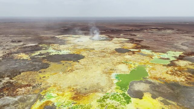 Aerial view of the Dallol hydrothermal field, showcasing colorful mineral deposits in northern Ethiopia&rsquo;s Afar Depression. Wide revealing drone footage.