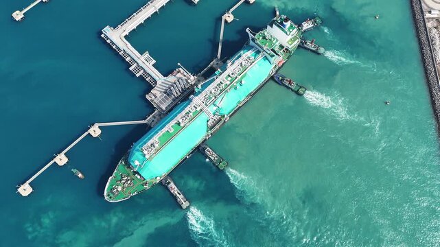 LNG (Liquified Natural Gas) tanker anchored in Gas terminal gas tanks for storage. Oil Crude Gas Tanker Ship. LPG at Tanker Bay Petroleum Chemical or Methane freighter export import transportation