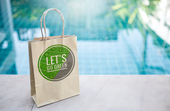Let's go green logo on paper bag over blurred blue swimming pool water background, eco friendly packaging, environmental friendly product