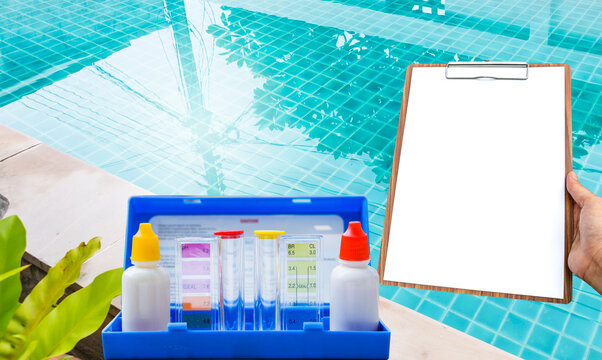 Water tester test kit with blank white paper over resort swimming pool background, quality water check, swimming pool maintenance and service