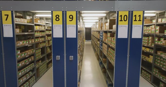 Interior view of a modern industrial warehouse with organized shelving units and numbered storage aisles