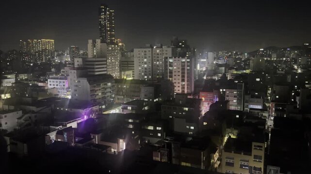 4K Cinematic night cityscape of Seoul, South Korea with urban buildings and lights.