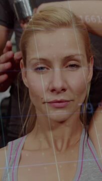 Salon client raising arm stylist lifting hair with tool digital grid floating over chest securing