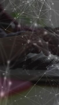 Hands starting typing on laptop keys for tech demo, initiating animated network overlay over hands