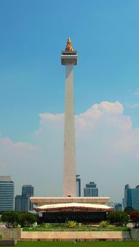 Jakarta, Indonesia - April 2, 2026: Timelapse of Monas or National Monument standing with clear sky. National Monument is Jakarta's famous landmark.