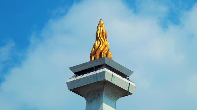 Jakarta, Indonesia - April 2, 2026: Timelapse of Monas or National Monument standing with clear sky. National Monument is Jakarta's famous landmark.