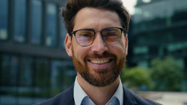 Smiling Caucasian business man in glasses outside city downtown looking camera positive cheerful middle aged happy male guy manager entrepreneur boss corporate headshot professional success executive