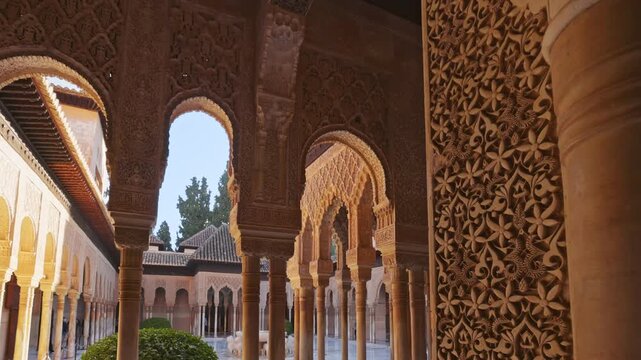 Magnificent stone carvings decorate the arches of Alhambra palace in Granada. Detailed view of the Moorish architecture in the Court of Lions in Alhambra. Gimbal shot, 4K