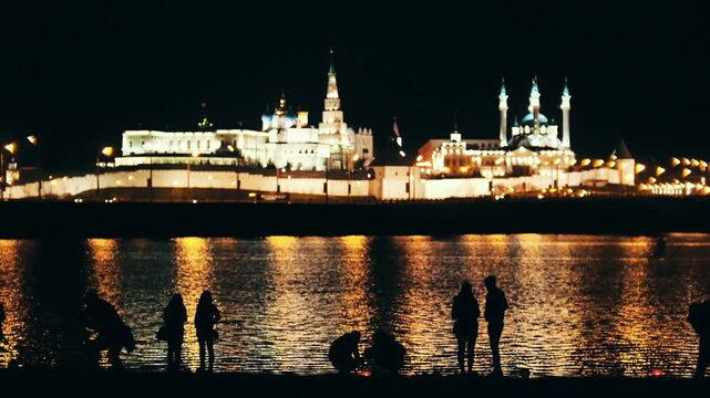 People silhouetted against kazan kremlin night view