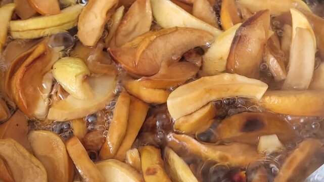 Stirring with a spoon, we cook a compote of dried fruits in a saucepan