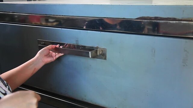 Video of raw chocolate chip cookies being placed in the oven.
