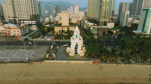 Aerial 4K view of Tram Huong Lotus Tower at sunrise in Nha Trang, Vietnam
the unique lotus-shaped architecture of the tower against the backdrop of modern high-rises like the Hyatt Regency and the cal