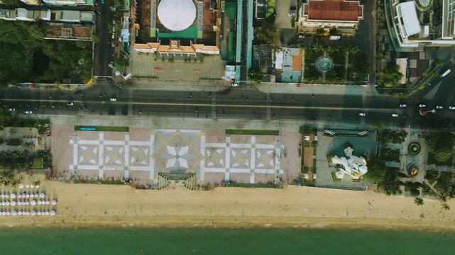 Top down aerial view of Nha Trang beach promenade and Tram Huong Tower
drone shot looking down at the April 2 Square and the beach promenade in Nha Trang. the geometric patterns of the tiled square