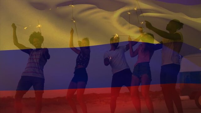 Animation of waving of columbia flag over group of friends on the beach