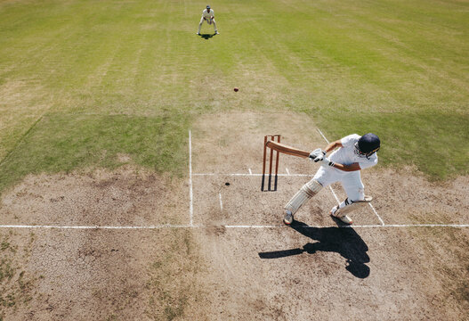 Cricket batsman playing a reverse shot during a match