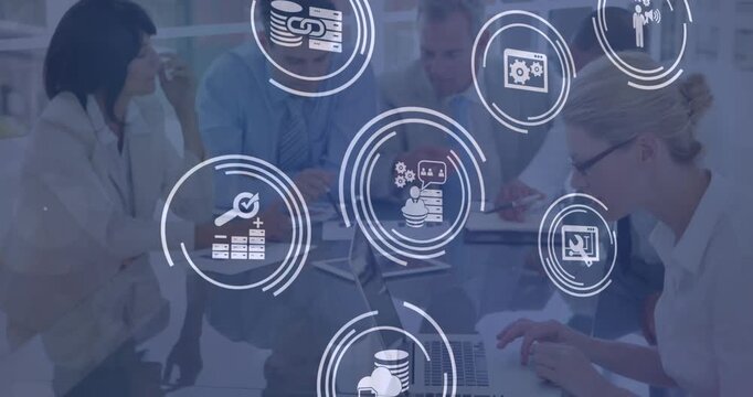Animation of multiple digital icons over diverse colleagues discussing together at office