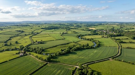 Obraz premium An aerial view of a landscape with vast green fields, open rural geometry and calm natural space beneath soft sunlight, ultra-realistic, no logos.