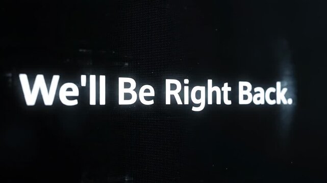This captures a technical difficulties message on a black screen with white text. The screen displays a message saying We'll Be Right Back.