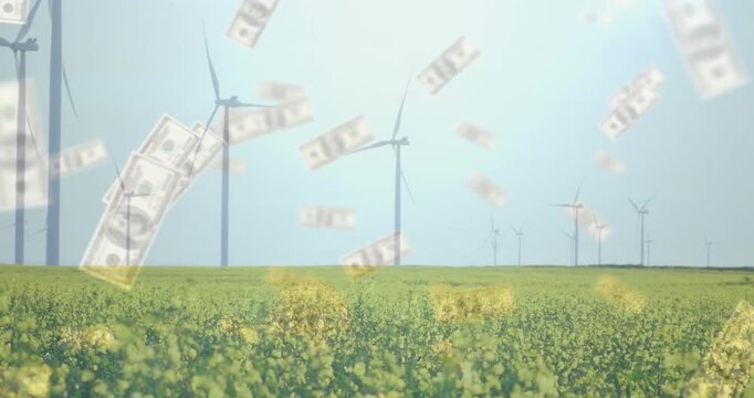 Falling money animation over wind turbines in field