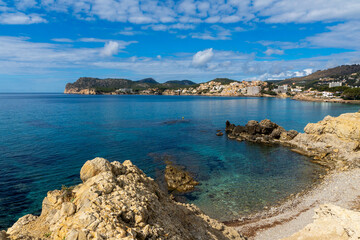 Fototapeta premium Panoramic view of turquoise bay and rocky coastline in Peguera Mallorca with clear water 