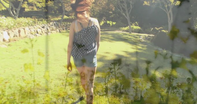 Woman walking lawn, sunlit path inviting steps, floral overlay merging, heading to shade for health