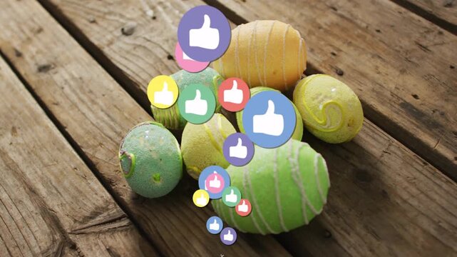 Painted eggs resting on wood plank, reaction icons appearing from bottom showing social engagement
