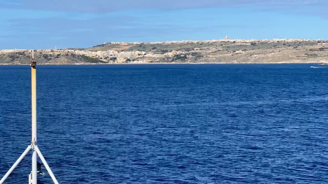 Ferry crossing the blue sea to the island of gozo in malta