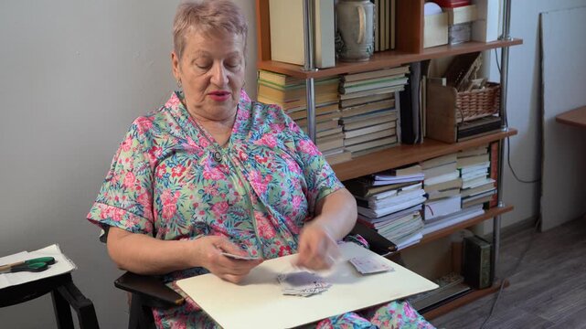 Elderly senior woman plays a card game. Shuffle and deal cards