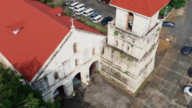 Close aerial view of Baclayon Church bell tower and stone facade in historic town Bohol Philippines, drone