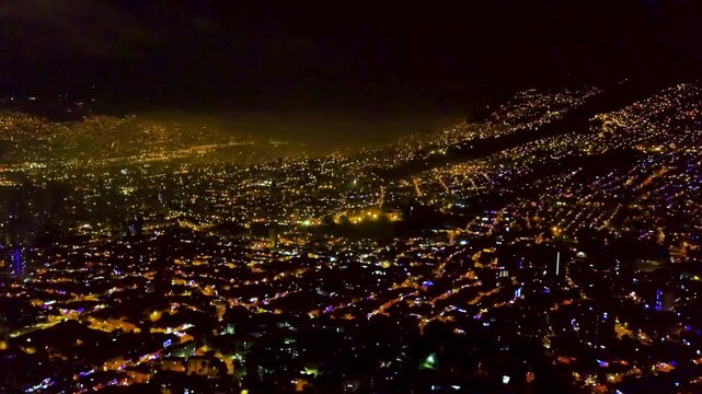 Aerial of New Year&rsquo;s Eve firework flashes over Medell&iacute;n cityscape in Colombia