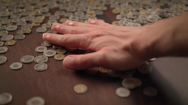 hand holding coin savings in slow motion. Money cash coins concept background