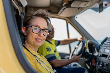 Paramedics driving ambulance on a sunny day © Jorge