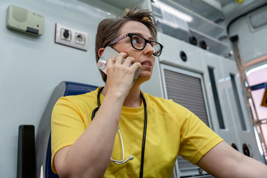 Paramedic making a phone call inside an ambulance