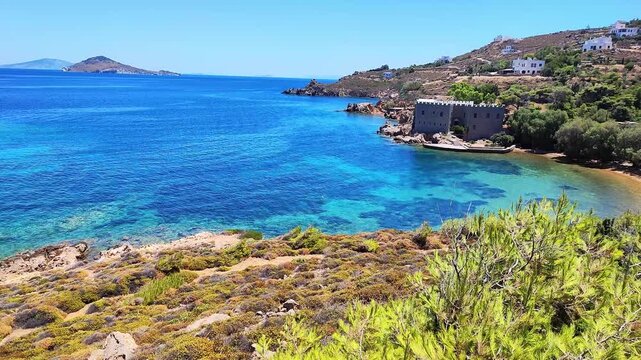 The beach Loukakia with the Hermitage of Agios Nektarios and the islet of Pilafi in Patmos island, Greece