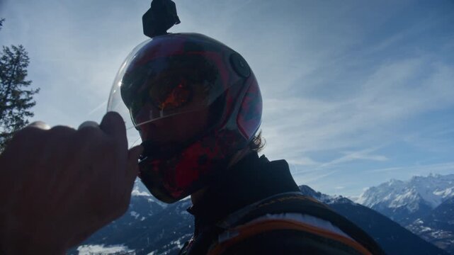Wingsuit BASE jumper flying over Verbier surrounded by alpine mountains with snow-covered peaks. High-speed flight, dramatic scenery, and cinematic extreme sports action in the Swiss Alps.